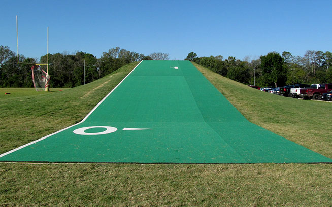 Long strip of green turf running up a grass training hill